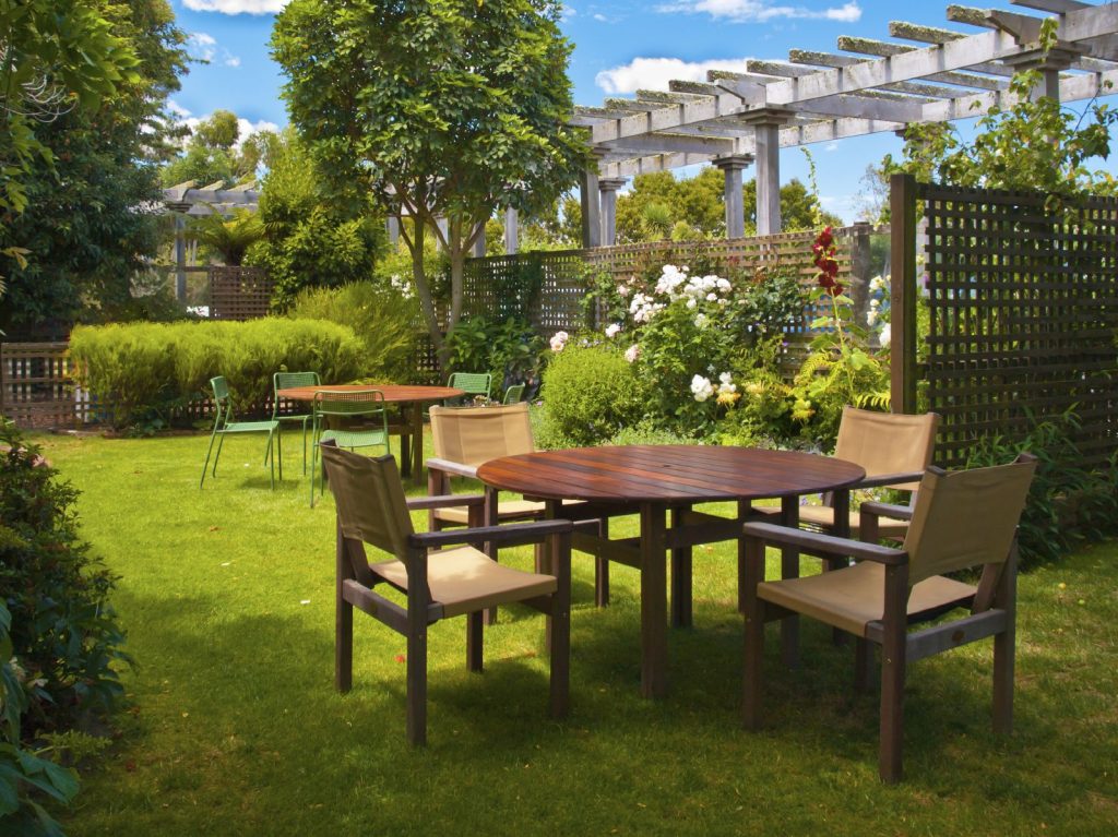 Landscaped Garden with Wooden Dining Table Set in the Shade of Trees