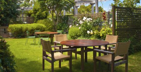 Landscaped Garden with Wooden Dining Table Set in the Shade of Trees