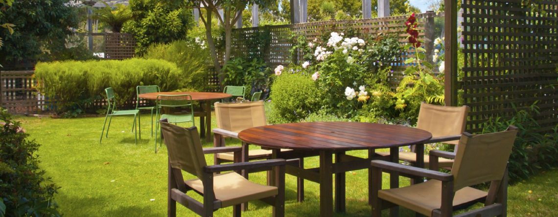 Landscaped Garden with Wooden Dining Table Set in the Shade of Trees